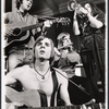 Nick Rawson [background left with guitar], Dave Ringland [foreground with guitar], Elizabeth Herring [standing right with trumpet] and unidentified [with flute] in the 1969 stage production Stomp