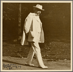 Six photographs of SLC strolling in white suit at Tuxedo, Aug. 1907. SLC walking towards camera.