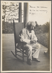 Seven photographs. SLC on a verandah, smoking. Photograph series, "the progress of a moral purpose..." 2 of 7