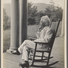 Seven photographs. SLC on a verandah, smoking. Photograph series, "the progress of a moral purpose..." 5 of 7