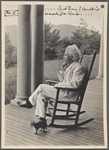 Seven photographs. SLC on a verandah, smoking. Photograph series, "the progress of a moral purpose..." 5 of 7