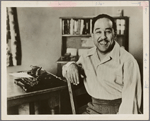 Portrait of writer Langston Hughes with his typewriter
