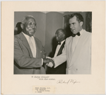 Journalist George Schuyler meeting Vice President Richard M. Nixon, who was running for re-election, during a political campaign stop at the Hotel Theresa, in Harlem, New York, in 1956. Journalist and New York State Republican Party Committee member Julius J. Adams is in the background