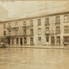 Old tenement row; glimpse of 23rd Police Precinct building