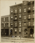 Tenements & industrial building; women & children outside; worker outside Metal Cleaning Co.