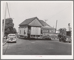 Old house being moved to make room for expansion of Arden Farms Creamery. San Diego, California