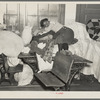 A young flood refugee sleeping amid salvaged household goods in a schoolhouse at Sikeston, Missouri