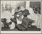 A young flood refugee sleeping amid salvaged household goods in a schoolhouse at Sikeston, Missouri