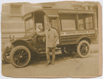 Mail carrier Wesley A. Williams posing with his United States Mail delivery truck