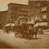 Horse driven streetcar with passengers on roof; storefronts (A. Wadley florist)