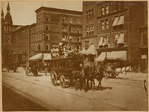 Horse driven streetcar with passengers on roof; storefronts (A. Wadley florist)