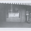 Exterior view of local Student Nonviolent Coordinating Committee headquarters in unidentified location, with sign bearing group's name and SNCC posters displayed in the window, circa early 1960s.