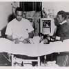An unidentified African American physician, assisted by a nurse, treating a baby born with a club foot at an unidentified public health clinic, circa 1945