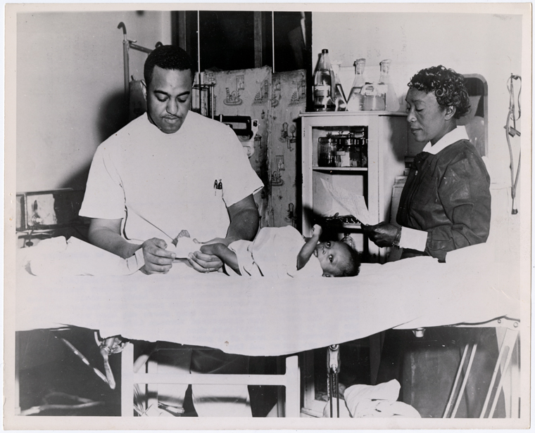 Doctor treating a baby born with a club foot