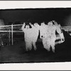 People and fence, printed in negative