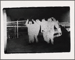 People and fence, printed in negative