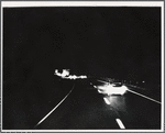 Automobiles on the highway at night