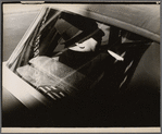 Passenger seen through a car window