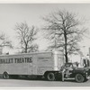 A man in casual dress standing in front of a Ballet Theatre truck, no. 24