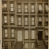 Brownstones; woman leaning out window
