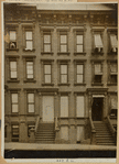 Brownstones; woman leaning out window
