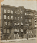 Ivy covered brownstones; boulevard type lamp