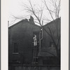 Man on ladder, London.