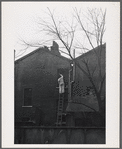 Man on ladder, London.