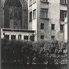 Man sleeping on a sidewalk beneath a stained-glass window