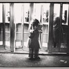 Woman and telephone booths in a bus terminal