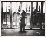 Woman and telephone booths in a bus terminal