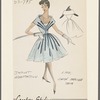 Knee-length lace dress with wide shawl collar and dark satin applique trim bands radiating from belt buckle