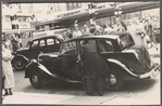 Crowd watching a celebrity (?) exiting a car