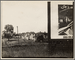 Houses with partial view of billboard advertising Coca-Cola in foreground. West Virginia?