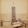 The obelisk "Cleopatra's Needle" surrounded by scaffolding with workers at top