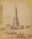 The obelisk "Cleopatra's Needle" crated and machinery attached for lowering