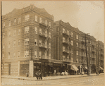 Apartment buildings with storefronts; Levitt's Café, Wine & Liquor store