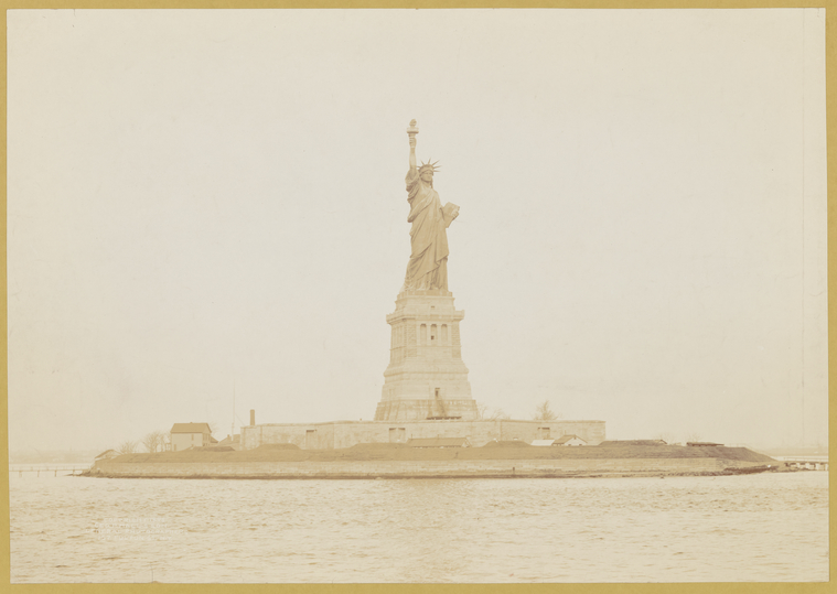 Sepia photo of Statue of Liberty on Ellis island