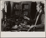 Woman running spinning wheel at Crossville, Tennessee Cumberland Homesteads.