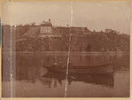 Two men in small boat; view of Fort Wendel amusement park