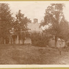 Poe Cottage on original site, man wearing boater hat on grounds