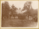 Poe Cottage on original site, man wearing boater hat on grounds