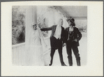 Scene from the motion picture Call of Her People (bride and two men standing)