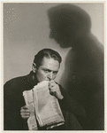 Alexander Kirkland (with newspaper) in the stage production Case of Clyde Griffiths