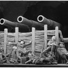 Soldiers in repose with cannons overhead in the stage production Johnny Johnson