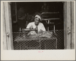 Scene in New Orleans, Louisiana. A street tailor