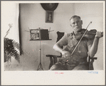 One of the Westmoreland homesteaders playing his violin, Pennsylvania