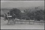Mother with baby carriage at scenic overlook