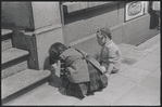 Boy and girl playing on sidewalk