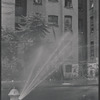 Street scene with open fire hydrant. New York, NY